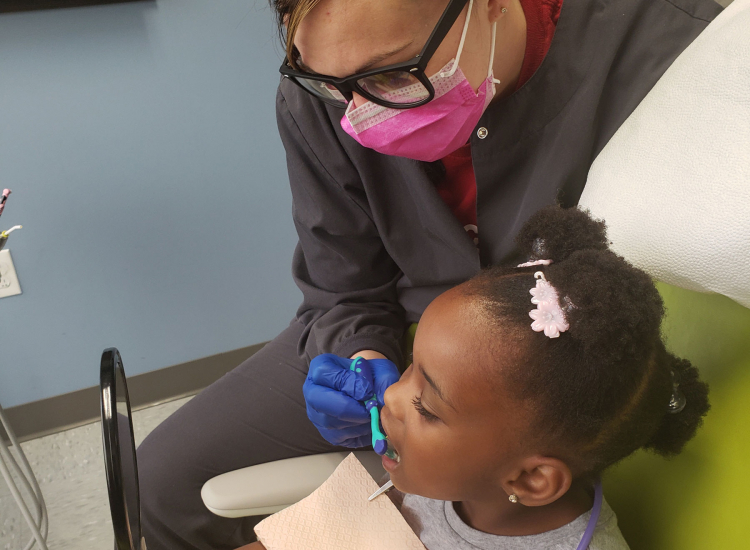 Child receiving dental care from Community Health Center